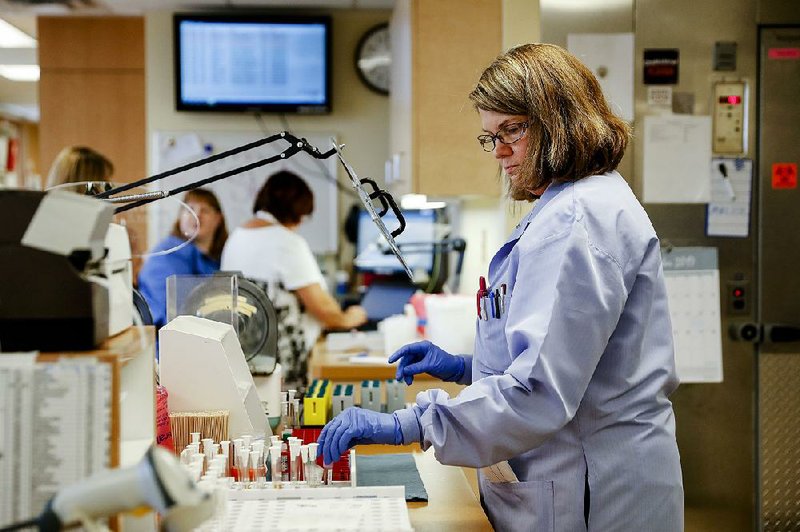 Laboratory personnel work last fall at University of Pittsburgh Medical Center Hamot in Erie, Pa. City leaders say Erie needs to retain such white-collar workers more than it needs a return to its blue-collar past. 