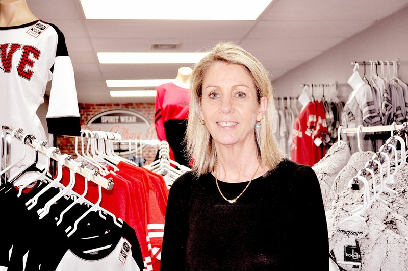 RACHEL DICKERSON/MCDONALD COUNTY PRESS Owner Tammy Clark is pictured at Fourstate Printing in front of screen-printed items for sale.