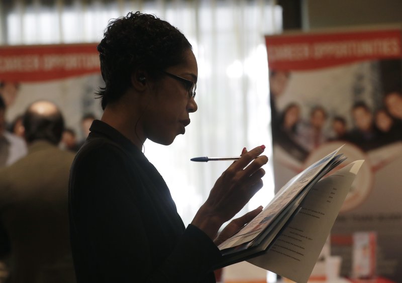 In this Tuesday, Jan. 30, 2018, photo, Joana Dudley, of Lauderhill, Fla., looks at her list of job prospects at a JobNewsUSA job fair in Miami Lakes, Fla. On Wednesday, March 7, 2018, payroll processor ADP reports how many jobs private employers added in February. (AP Photo/Lynne Sladky)