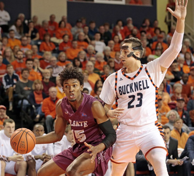 Colgate's Jordan Swopshire (15) drives on Bucknell's Zach Thomas (23) during the first half of an NCAA college basketball game for the Patriot League men's tournament championship in Lewisburg, Pa., Wednesday, March 7, 2018. (AP Photo/Chris Knight)