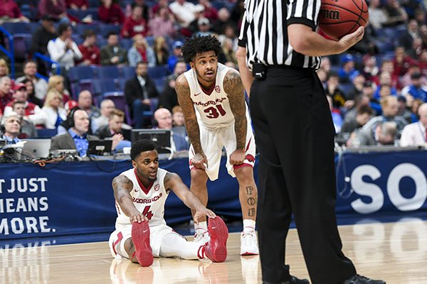 Arkansas guards Daryl Macon (4) and Anton Beard (31) look toward the sideline after Macon was fouled during a Southeastern Conference Tournament game against South Carolina on Thursday, March 8, 2018, in St. Louis. 