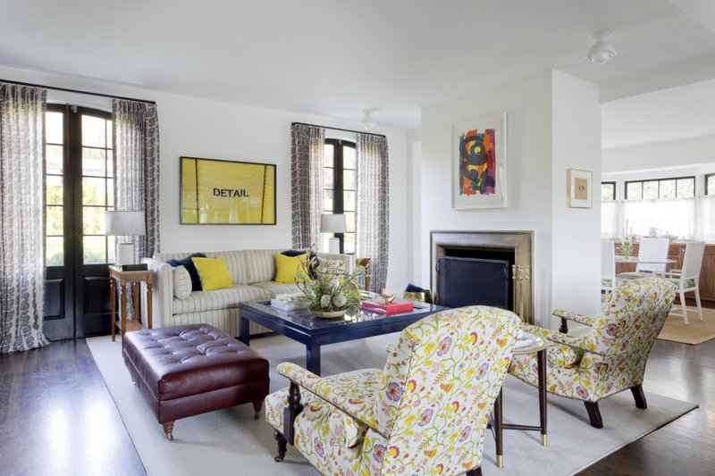 This photo provided by Amy Sklar Design shows two chairs in a room with floral prints. “As a designer, I love bold floral prints that feel modern but wink to the classics,” says designer Sklar. “The profile of this particular chair is very traditional, so adding a poppy pattern here makes it feel much more current, timeless and fun." Mixing styles is a hot trend now in décor and design. (Amy Bartlam/Amy Sklar Design via AP)