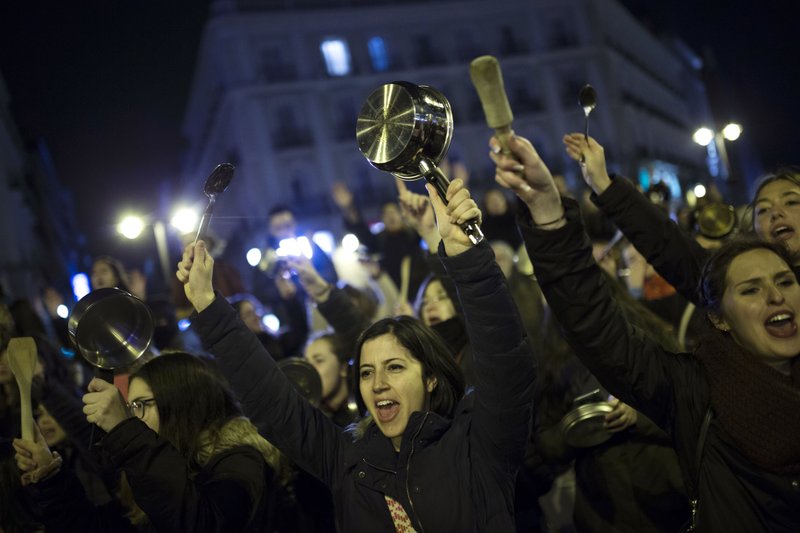 Women bang pots and pans as shooting slogans during a protest marking the beginning of a 24-hour women strike at the Sol square in Madrid, early Thursday, March 8, 2018. Women in Spain have been called for a 24-hour feminist strike in their workplaces and also stop doing duties at home during the International Women's Day. 