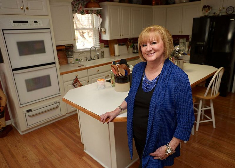 Susan Chase, executive director of the Chase Family Foundation, smiles Thursday, Feb. 15, 2018, in the kitchen of her Springdale home.