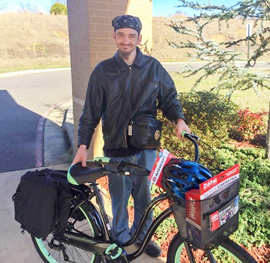 Submitted photo DONATION: Jonathan Smith, of Fountain Lake, received an anonymous donation at Ouachita Behavioral Health &amp; Wellness on Tuesday of a bicycle "with all the fixings," including saddlebags to carry his belongings, basket, bike lock, helmet, flashlight and water bottle. Smith has walked to his bi-weekly appointments at the clinic from his home in Fountain Lake for the past three years.