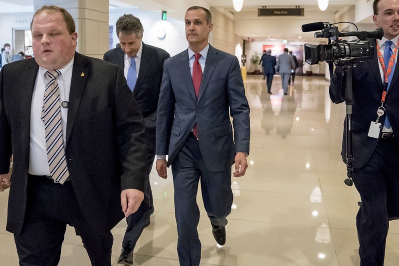 Former Trump campaign manager Cory Lewandowski, center, and his lawyer Peter Chavkin, second from left, arrive to meet behind closed doors with the House Intelligence Committee, at the Capitol in Washington, Thursday, March 8, 2018. (AP Photo/Andrew Harnik)