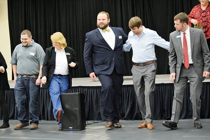 Heber Springs Area Chamber of Commerce board members, from left, Ryan Sartin, Toi Logan, Jeremy Bivins, Cody Davis and Brett Graham take part in the Boardwalk auction during the 2017 chamber banquet.