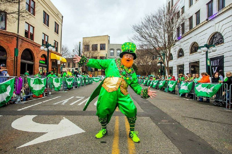 Monte Everhart, the World’s Tallest Leprechaun, dances at last year’s Worlds Shortest St. Patrick’s Day Parade. His activities  for  the day  include a VIP  lunch  for  sponsors and  celebrity guests, a Blarney Stone Kissing contest, officially measuring the parade route and pre-parade interaction with the crowd. Everhart says he has met attendees from Korea, Finland and England, and many from surrounding states.