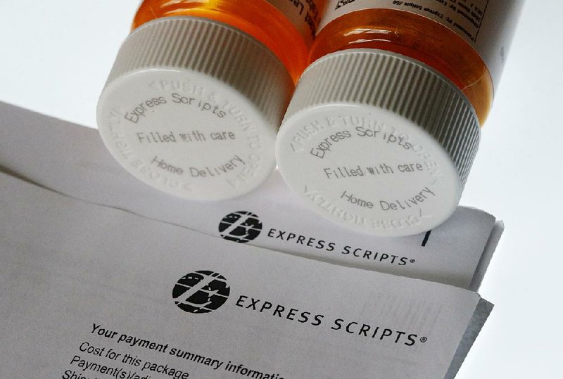 Express Scripts medication bottles are displayed in 2017. Express Scripts’ merger with insurer Cigna is the latest in a string of proposed health industry buyouts and tie-ups.