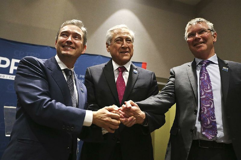 Canada’s international trade minister Francois-Philippe Champagne (left), Chilean Foreign Minister Heraldo Munoz and New Zealand Trade Minister David Parker prepare to sign the Comprehensive and Progressive Agreement for Trans-Pacific Partnership on Thursay in Santiago, Chile.
