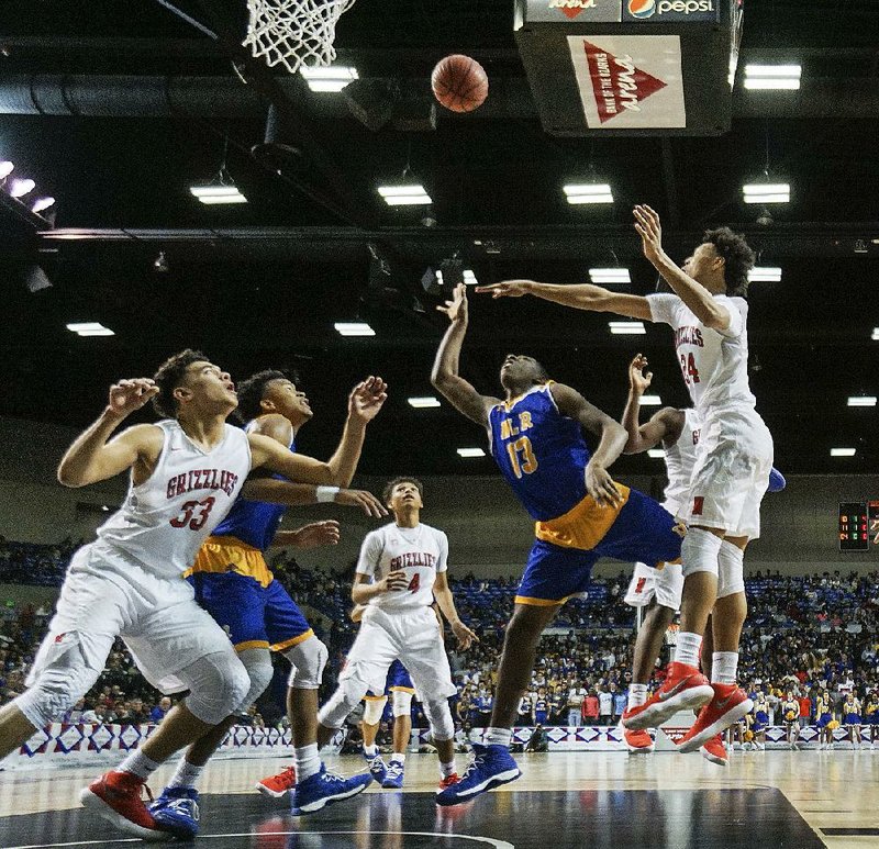 North Little Rock’s Spencer Simes (13) puts up a shot near three Fort Smith Northside defenders Thursday during the Charging Wildcats’ 64-51 victory over the Grizzlies at Bank of the Ozarks Arena in Hot Springs. Simes scored 11 points for the Charging Wildcats, who avenged a loss to the Grizzlies in last year’s Class 7A boys championship game. 