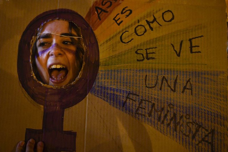 A participant in an International Women’s Day rally in Pamplona, Spain, on Thursday makes her voice known through a cardboard display that reads in Spanish: “This is what feminism looks like.”