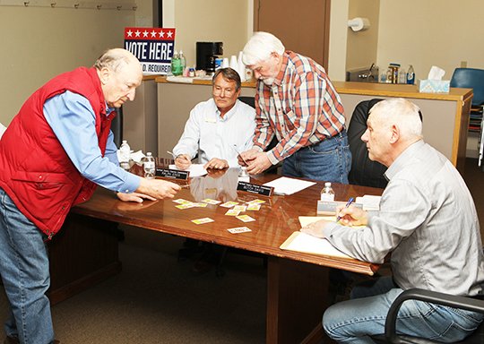 The Sentinel-Record/Richard Rasmussen HIGH CARD WINS: Dennis Bosch, left, draws a card for a candidate not in attendance at Friday's ballot draw at the Garland County Election Commission Building. Commissioners Ralph Edds, Butch Davis and Gene Haley look on to see which candidates will be listed higher on ballots in the May 22 preferential primaries, annual school election and nonpartisan general election.