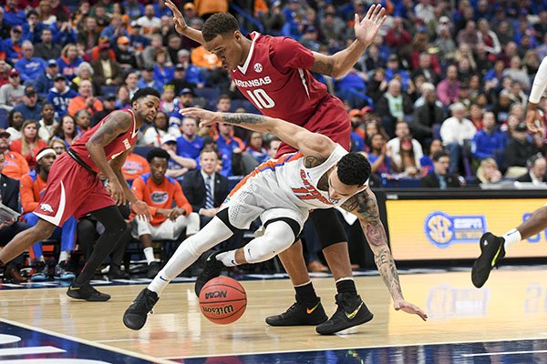 Arkansas' Daniel Gafford (10) collides with Florida's Chris Chiozza (11) during an SEC Tournament game Friday, March 9, 2018, in St. Louis. 