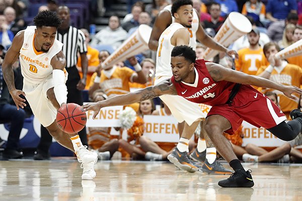 Tennessee's Jordan Bone, left, and Arkansas' Daryl Macon dive after a loose ball during the first half of an NCAA college basketball game in the semifinals of the Southeastern Conference tournament Saturday, March 10, 2018, in St. Louis. (AP Photo/Jeff Roberson)

