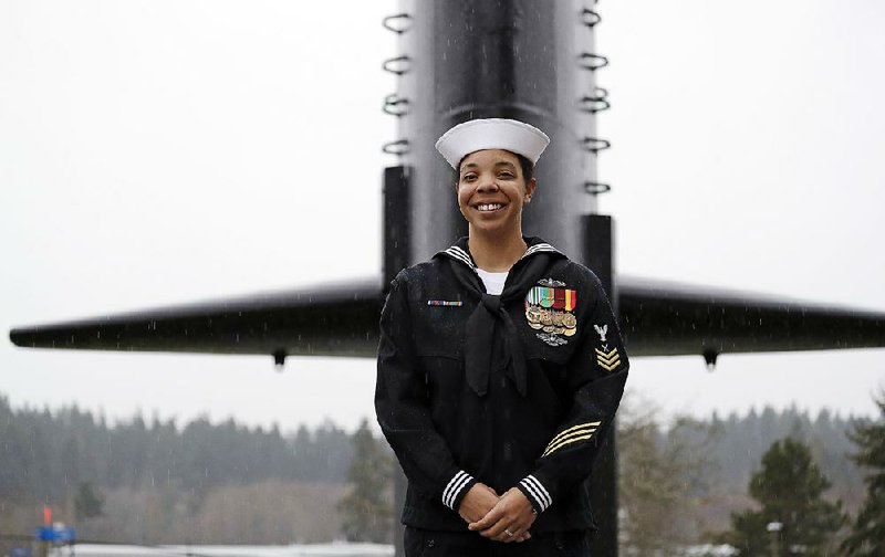 Yeoman 1st Class Suraya Mattocks stands near a submarine at the U.S. Naval Undersea Museum near her base in Keyport, Wash. Mattocks, one of the first women sailors to serve in the submarine fleet, says she “found something I love, something new in the Navy that I love.” 