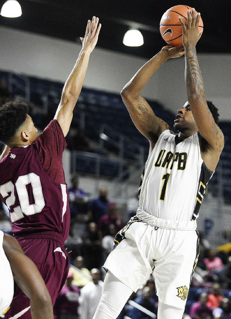 UAPB guard Charles Jackson (1) shoots as Texas Southern guard Cainan McClelland (20) defends during the Golden Lions’ 84-69 loss to Texas Southern in the SWAC championship game in Houston.