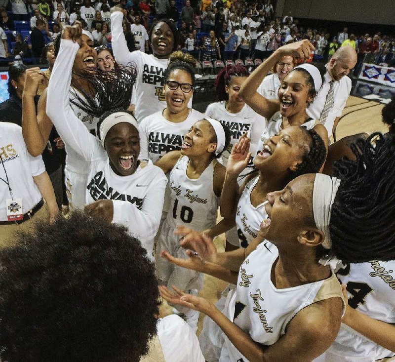 Hot Springs players celebrate after the Lady Trojans defeated Watson Chapel in the Class 5A girls championship game Saturday night at Bank of the Ozarks Arena in Hot Springs.