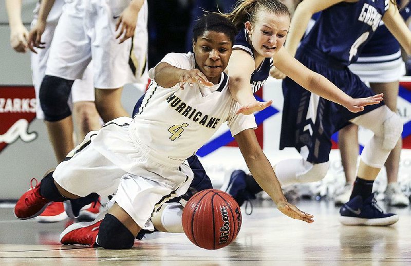 Jonesboro’s Kayla Mitchell (front) and Greenwood’s Kinley Fisher scramble for a loose ball Saturday during the Lady Hurricane’s 57-44 victory over the Lady Bulldogs in the Class 6A girls state championship game at Bank of the Ozarks Arena in Hot Springs.