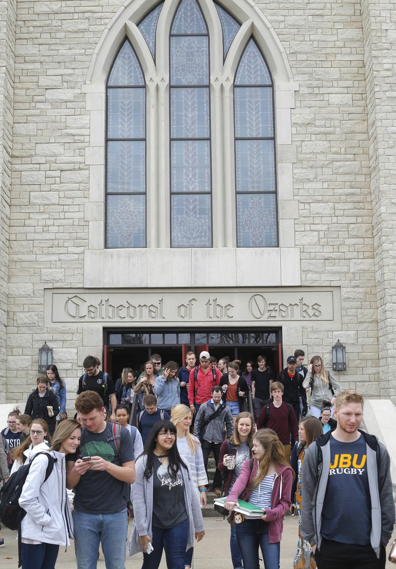 NWA Democrat-Gazette/DAVID GOTTSCHALK Students leave the Cathedral of the Ozarks on the campus of John Brown University in Siloam Springs.