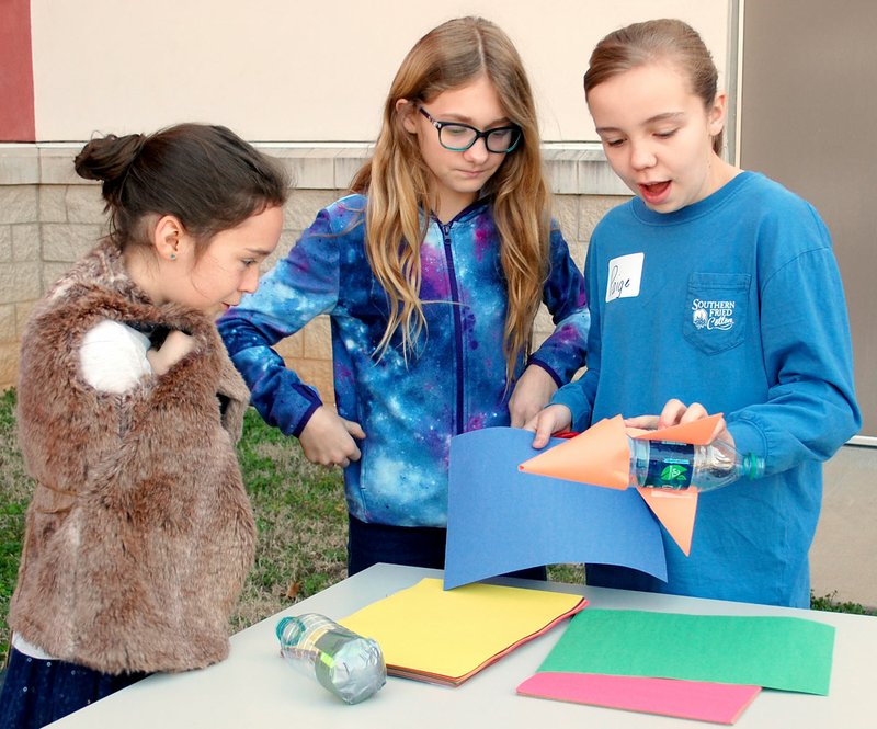 Janelle Jessen/Herald-Leader Girls talked over the best way to design a rocket, fueled by air pressure, during the Society for Women Engineers' "Introduce a Girl to Engineering Day" at John Brown University on March 3.