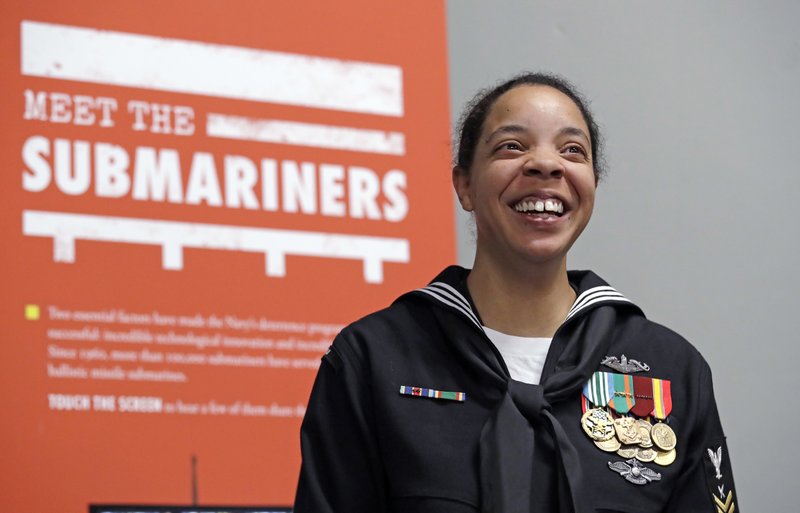 In this Jan. 18, 2018, photo, U.S. Navy YN1 Suraya Mattocks, one of the first female enlisted sailors to be selected to serve on submarines, poses for a portrait at the U.S. Naval Undersea Museum near her base in Keyport, Wash. The Navy began bringing female officers on board submarines in 2010, followed by enlisted female sailors five years later. Their retention rates are on par with those of men, according to records obtained by The Associated Press. (AP Photo/Elaine Thompson)