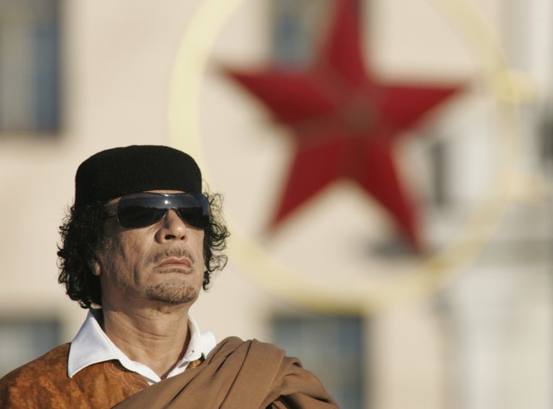 FILE - In this Nov. 3, 2008 file photo, Libyan leader Moammar Gadhafi attends a wreath laying ceremony in the Belarus capital Minsk. Gadhafi welcomed international inspectors to verify the process of dismantling Libya's chemical and nuclear weapons programs after Libya's longtime dictator Moammar Gadhafi unilaterally renounced weapons of mass destruction. (AP Photo/Sergei Grits, File)
