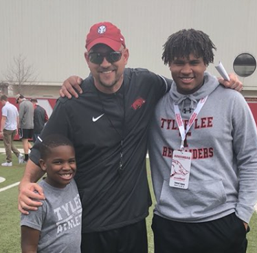 Sophomore tight end- linebacker Jamal Ligon and his younger brother Dalvin pose with associate head coach running backs coach Jeff Traylor. 