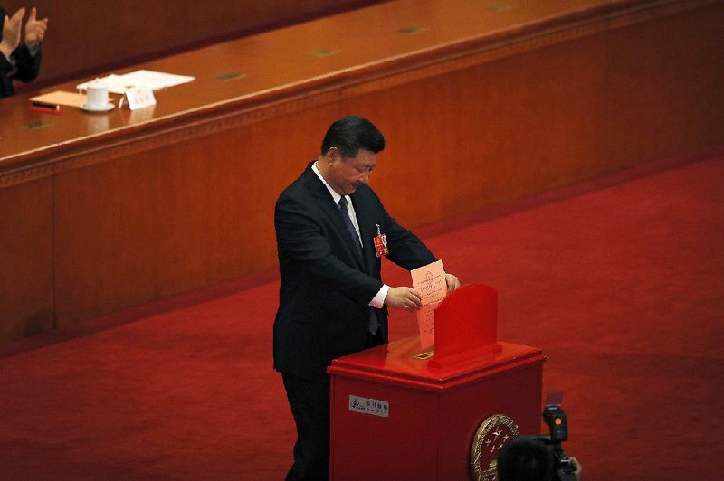 Chinese President Xi Jinping casts his vote Sunday for an amendment to China’s Constitution abolishing term limits on the presidency during a plenary session of the National People’s Congress at the Great Hall of the People in Beijing.