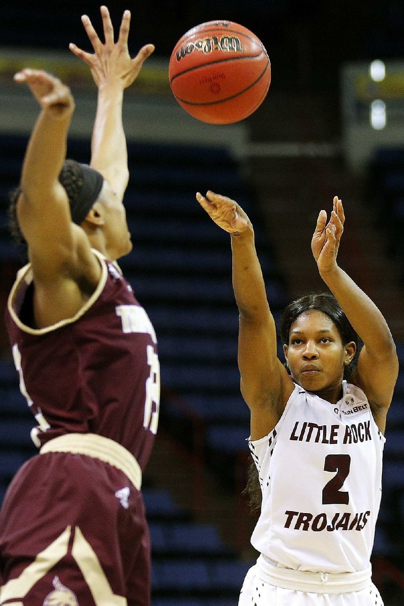 UALR guard Monique Townson (2) shoots over Texas State guard Taeler Deer (23) during the first half of the Sun Belt Conference Tournament championship Sunday in New Orleans. Townson finished with 17 points to lead the Trojans to a 54-53 victory over the Bobcats.