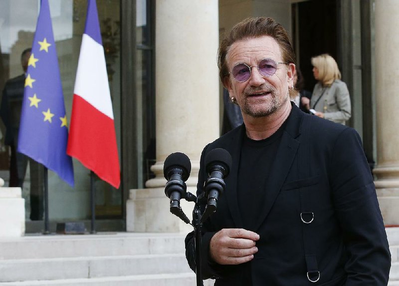 Founder of the non-governmental organization ONE, U2 singer Bono speaks to the media after a meeting at the Elysee Palace, in Paris, France, Monday, July 24, 2017. French President Emmanuel Macron has received pop singer and philanthropist Bono at the Elysee Palace in Paris for talks about poverty.(AP Photo/Michel Euler)