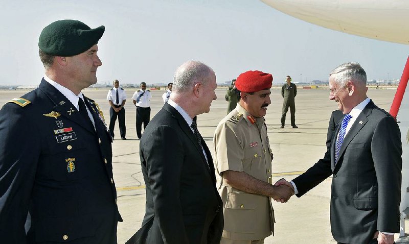 U.S. Defense Secretary James Mattis (right) greets Omani Brigadier Saleh bin Ahmed al-Hinai upon arriving Sunday at Seeb Air Base northwest of Muscat, Oman. In an interview before landing, Mattis said Russia “can sink all that money” into nuclear weapons, but it won’t change the Pentagon’s strategy.