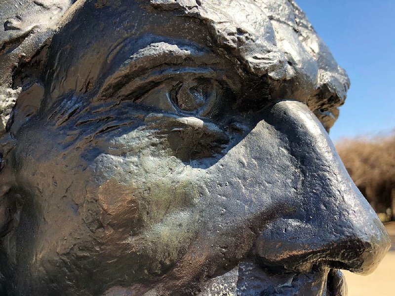 Sasha Alexandrovich Stanislav Schnittmann's 1961 bronze bust of Count Casimir Pulaski stands beside the Arkansas Blue Cross Blue Shield Wellness Walkway in Julius Breckling Riverfront Park on a chilly blue March 7, 2018.
