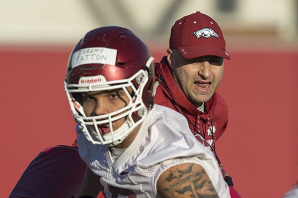 Barry Lunney, Jr., Arkansas tight ends coach, works with tigh end Jeremy Patton on a drill Thursday, March 1, 2018, during Arkansas spring football practice at the Fred W. Smith Football Center in Fayetteville. Barry Lunney, Jr., Arkansas tight ends coach, works with tigh end Jeremy Patton on a drill Thursday, March 1, 2018, during Arkansas spring football practice at the Fred W. Smith Football Center in Fayetteville.