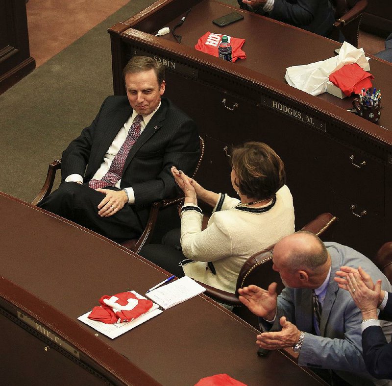 Members of the Arkansas House of Representatives, including Rep. Charlene Fite (center), R-Van Buren, and Rep. Mark McElroy (right), D-Tillar, applaud Monday afternoon for Rep. Matthew Shepherd (left), R-El Dorado, after he won the election to be the next speaker of the House.