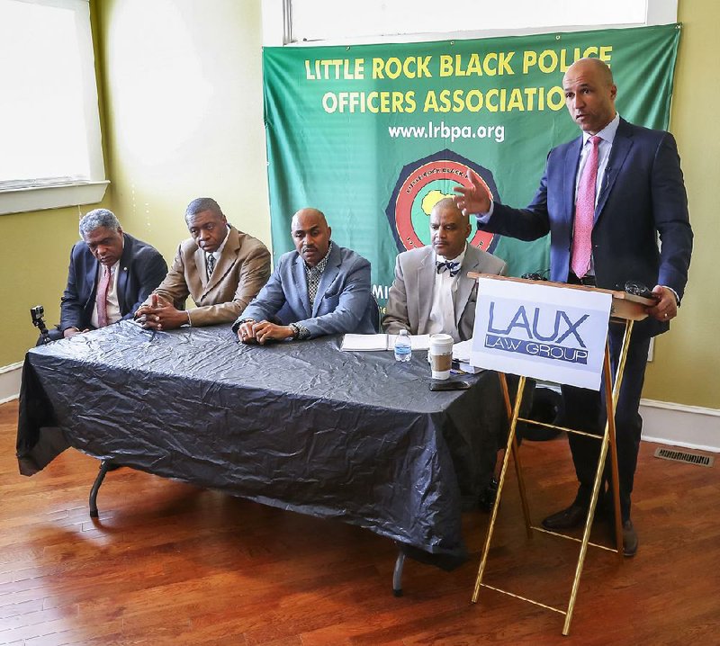 A discrimination lawsuit was filed Monday against Little Rock on behalf of four Police Department officers by attorney Mike Laux (standing) of the Laux Law Group. Seated from left are three plaintiffs Lt. Earnest Whitten, Sgt. Derrick Threadgill and Sgt. Willie Davis along with Lt. Johnny Gilbert Jr.