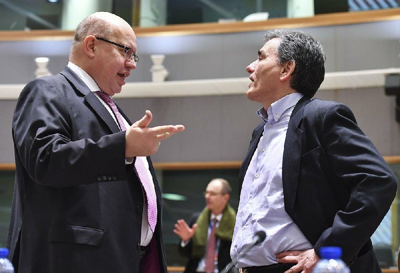 Peter Altmaier (left), Germany’s acting chief of finance, speaks Monday with Greek Finance Minister Euclid Tsakalotos during a meeting in Brussels.