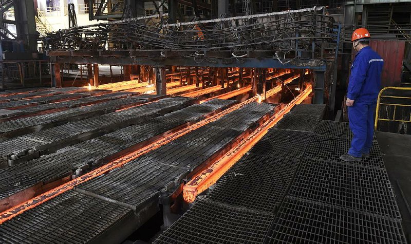 A steelworker at Xiwang Special Steel in Zouping County in eastern China’s Shandong province oversees production last week. Chinese steel mills account for half the world’s steel production.

