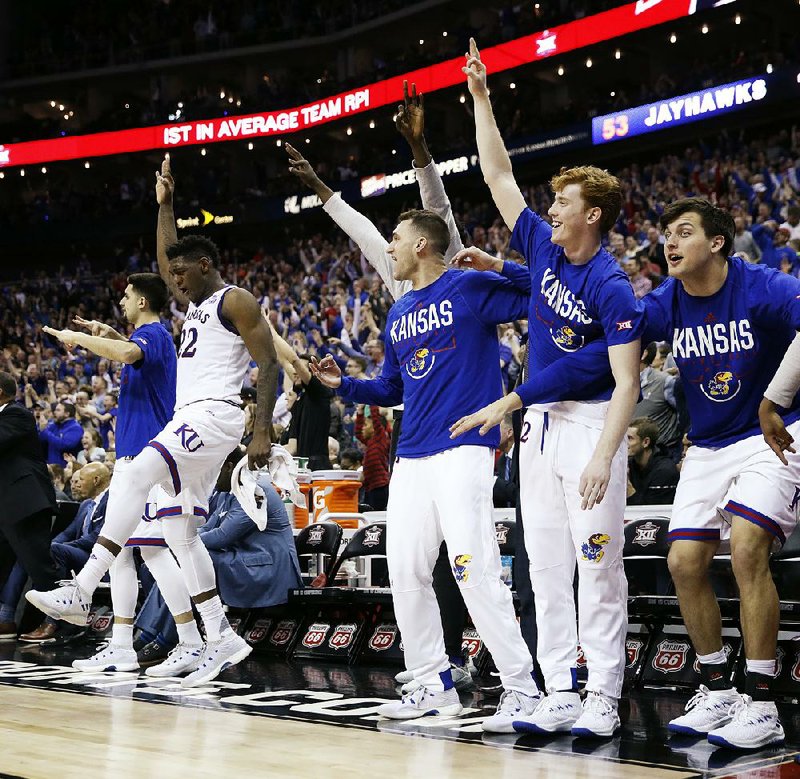 Kansas players celebrate during the second half of the Big 12 Conference Tournament championship Saturday against West Virginia in Kansas City, Mo. Kansas is among the teams in a top-heavy Midwest Region.