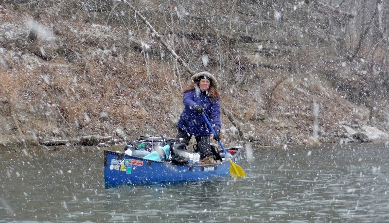 Amanda Kay Whelchel-Harris stands Feb. 5 to find a floatable channel on the Meramec River as a snow storm begins while floating. Eight paddlers from the Fayetteville area spent Feb. 2-10 floating 46 miles of the spring fed river in Missouri.