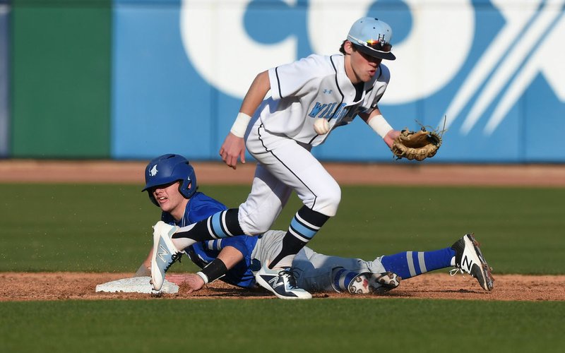 NWA Democrat-Gazette/J.T. WAMPLER Springdale Har-Ber's Mac McCroskey can't keep a hold of the ball while Rogers' Brandon Husted slides to second base Monday March 12, 2018 at Arvest Ballpark in Springdale. Rogers beat the Wildcats 1-0.