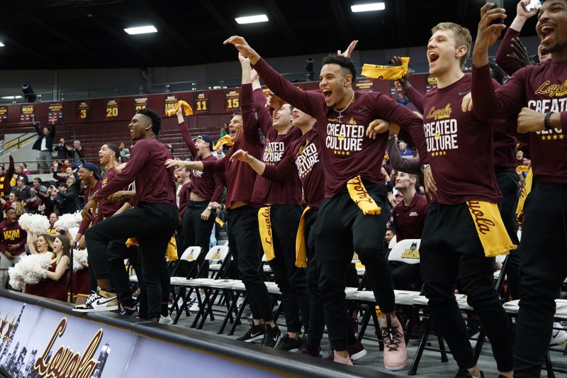 Loyola men's basketball players celebrate after the team was selected to play in the NCAA Tournament during a selection show watch party at Gentile Arena Sunday, March 11, 2018 in Chicago. (Armando L. Sanchez/Chicago Tribune via AP)