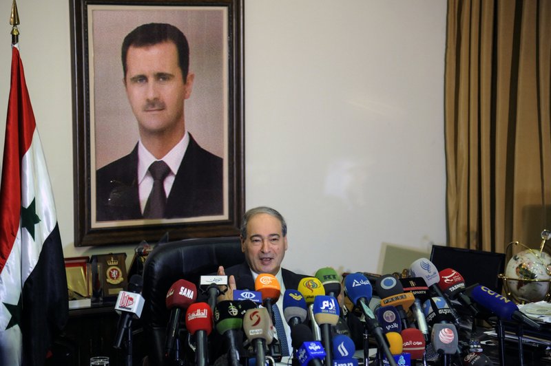This photo released by the Syrian official news agency SANA, Syrian Deputy Foreign Minister Faisal Mekdad, speaks during a news conference in Damascus, Syria, Saturday, March 10, 2018. Mekdad denied opposition charges that government forces used poison gas in their attacks on eastern Ghouta. Mekdad added that insurgents groups in the eastern Ghouta are preparing &quot;to fabricate&quot; more such attacks to blame the Syrian army. (SANA via AP)