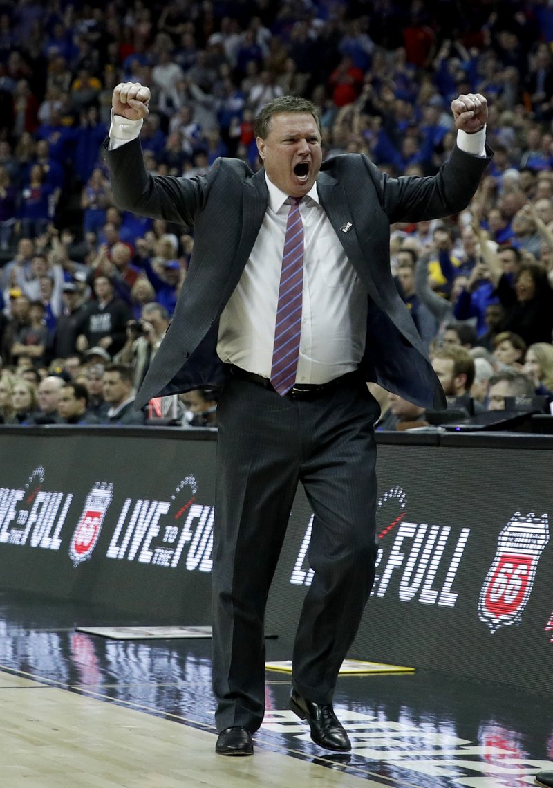 Kansas head coach Bill Self celebrates after winning the NCAA college basketball championship game against West Virginia in the Big 12 men's tournament Saturday, March 10, 2018, in Kansas City, Mo. Kansas won 81-70. (AP Photo/Charlie Riedel)