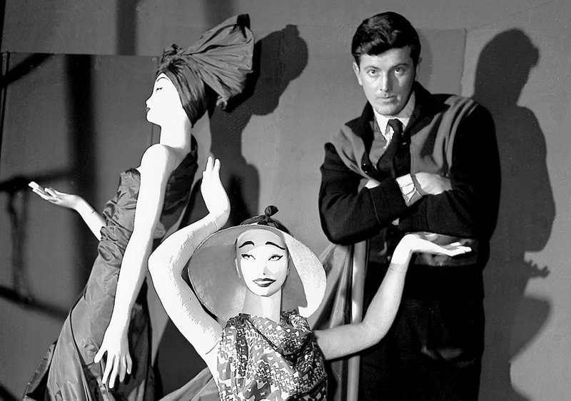 FILE - In this Feb.1 1952 file photo, French fashion designer Hubert de Givenchy poses with mannequins in his shop in Paris. French couturier Hubert de Givenchy, a pioneer of ready-to-wear who designed Audrey Hepburn's little black dress in "Breakfast at Tiffany's" has died at the age of 91. (AP Photo, File)