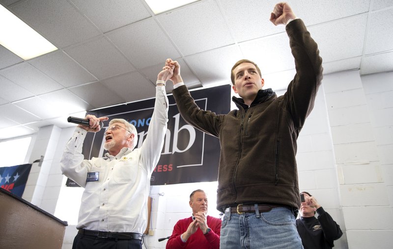 Cecil Roberts, president of the United Mine Workers, left, lifts up Democratic candidate Conor Lamb's hand as the crowd erupts in cheers and chants during a rally, Sunday, March 11, 2018, at the Greene County Fairgrounds in Waynesburg, Pa. Lamb is running against state Rep. Rick Saccone for Pennsylvania's 18th Congressional District in a special election on Tuesday. (Antonella Crescimbeni/Pittsburgh Post-Gazette via AP)