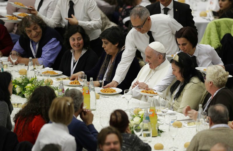 In this Nov. 19, 2017 file photo, Pope Francis is served gnocchetti during a lunch with several hundred poor people, at the Vatican on World Day of the Poor. When Cardinal Mario Jorge Bergoglio appeared five years ago, on March 13, 2013, at the main window of St. Peter’s Loggia in a white cassock and without solemnity greeted the chanting crowd in the square with a casual ‘buonasera’ (good evening) it was immediately apparent that Pope Francis’s style would be different, folksier than that of other popes.  (AP Photo/Andrew Medichini, files)