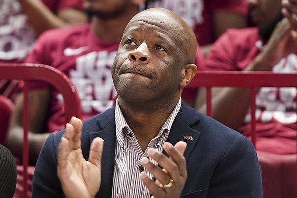 Arkansas Razorbacks head coach Mike Anderson (center) and his wife Marcheita Anderson (left) watch the NCAA selection show, Sunday, March 11, 2018 at Bud Walton Arena in Fayetteville. 