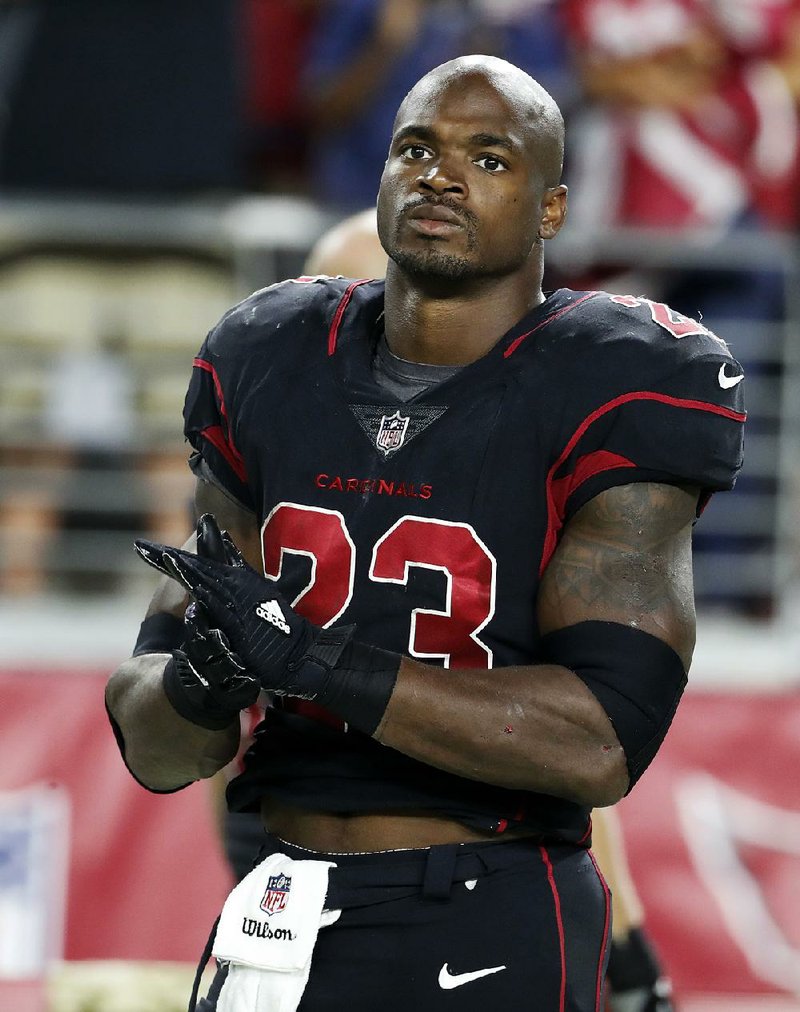 FILE - In this Nov. 9, 2017, file photo, Arizona Cardinals running back Adrian Peterson watches from the sideline during an NFL football game against the Seattle Seahawks in Glendale, Ariz.  The Cardinals released Peterson on Tuesday, March 13, 2018, after a half-season in the desert that included a pair of impressive games and a season-ending injury. (AP Photo/Rick Scuteri, File)