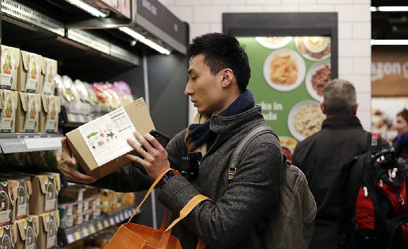 Paul Fan shops at an Amazon Go store in Seattle in January. Consumer prices increased at a modest pace in February, according to U.S. Labor Department.